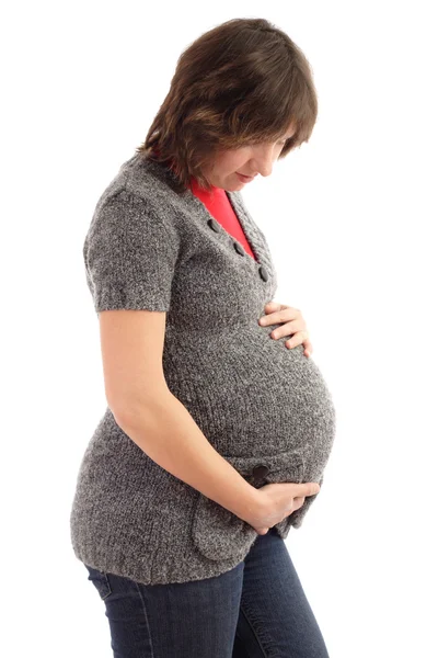 Беременная женщина обнимает живот — стоковое фото