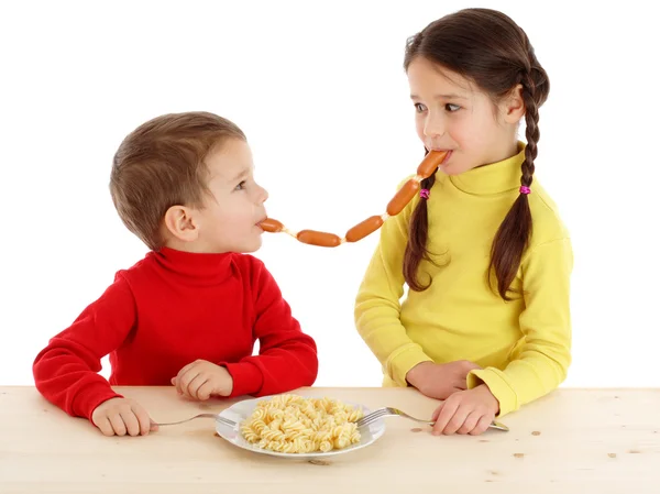 Little children sharing the chain of sausages — Stock Photo, Image