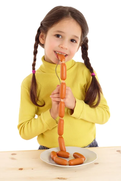 Smiling little girl eating the chain of sausages — Stock Photo, Image