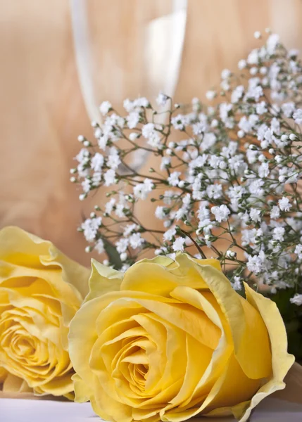 Yellow roses and glass of wine — Stock Photo, Image