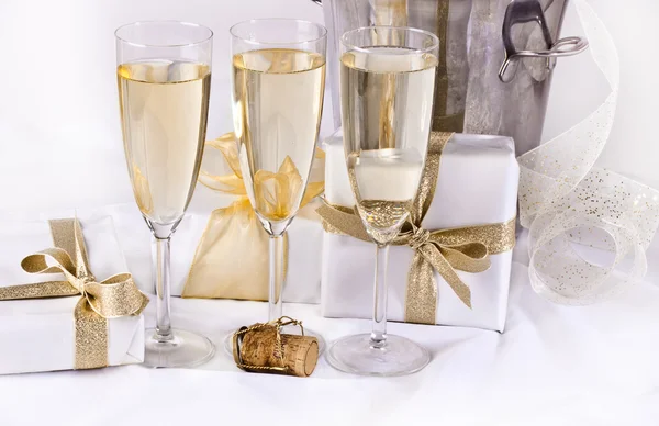 Glasses of champagne and gifts — Stock Photo, Image