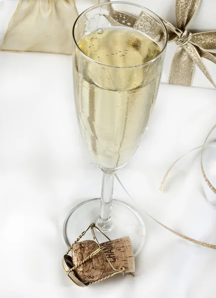 Glass of champagne and gifts — Stock Photo, Image