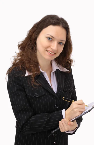 Сяюча молода бізнес-леді робить нотатки на її кишені проти білого б — стокове фото