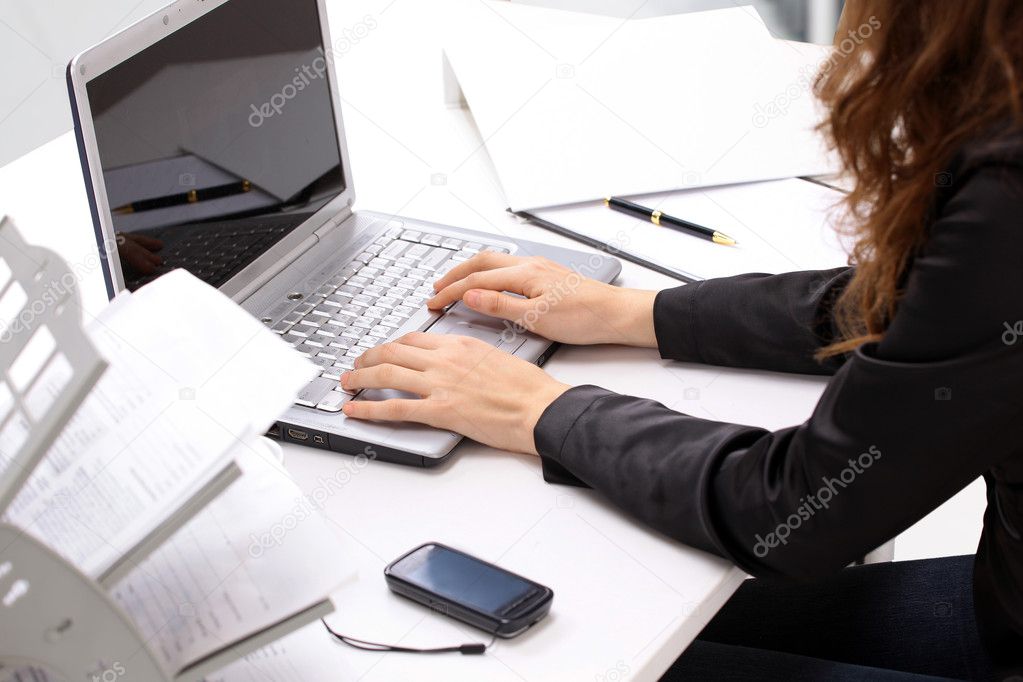 Female hands typing on a keyboard and holding mouse