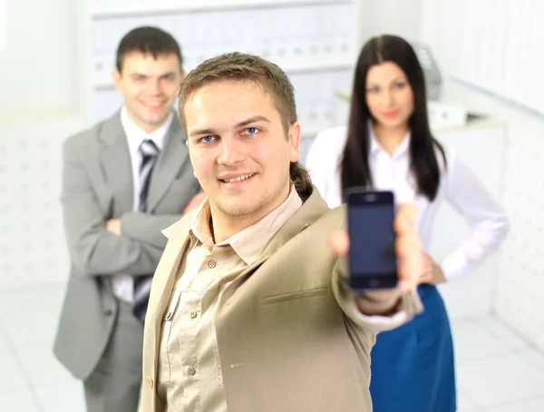 Νέος επιχειρηματίας που μιλάει στο κινητό στέκεται στο γραφείο διάδρομο. — Φωτογραφία Αρχείου