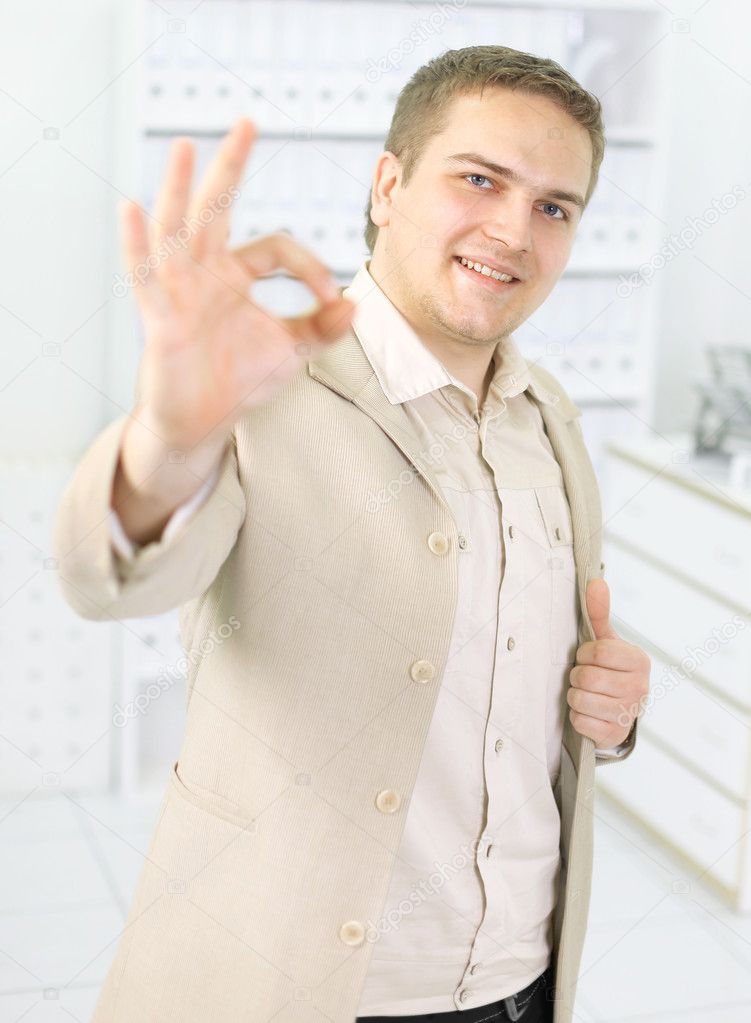 Happy businessman with okay gesture, isolated on white