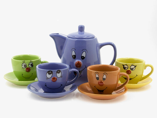 Four kid 's tea cups on saucers with a teapot.There are curious smiling faces on one side of five subjects
