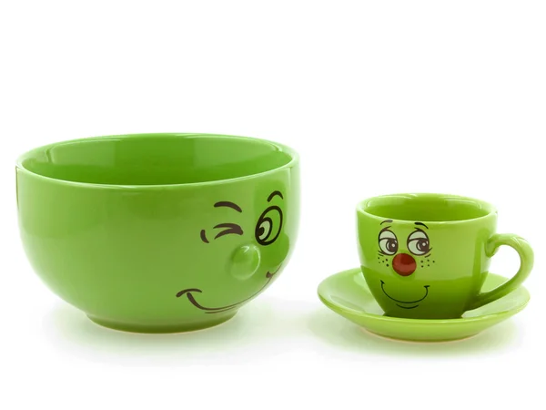 Una ciotola verde Accanto a una tazza verde per bambini Foto Stock Royalty Free