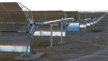 Panoramic view of solar parabolic mirrors for producing solar power clipart