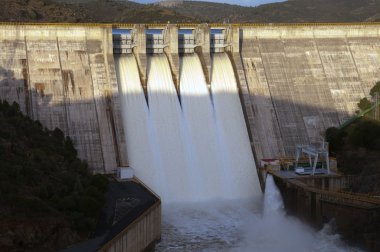 Detail of open gates open of a dam clipart