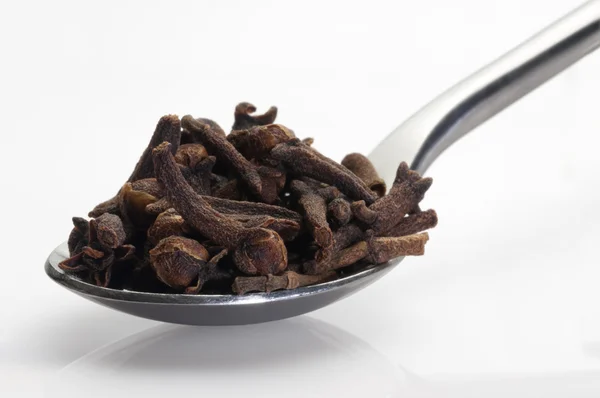 Cloves in a spoon — Stock Photo, Image