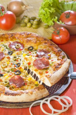 A piece of pizza with hot cheese is lifting up clipart