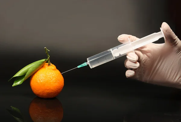 stock image Tangerine GMO. Tangerine and syringe