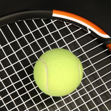 Tennis racket and ball on black clipart