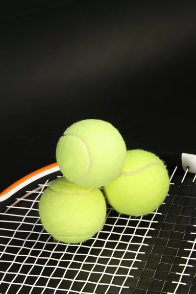 Tennis racket and balls on black — Stock Photo, Image