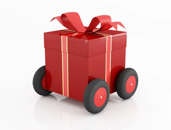 Rote Geschenkbox auf Rädern — Stockfoto