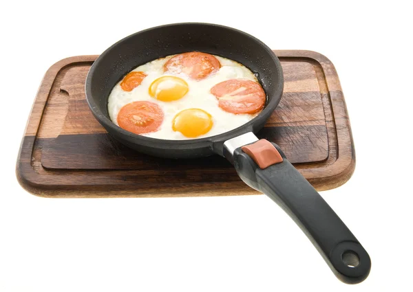 stock image Fried eggs with tomatoes just cooked in a pan