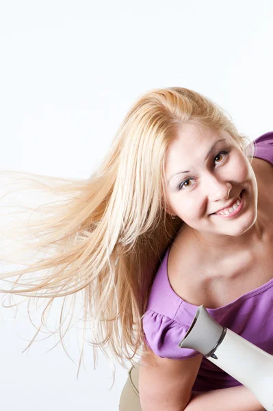 Retrato de una chica con un secador de pelo — Foto de Stock