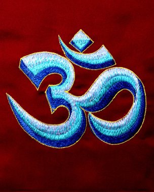 Om symbol embroidered thread on a red background clipart