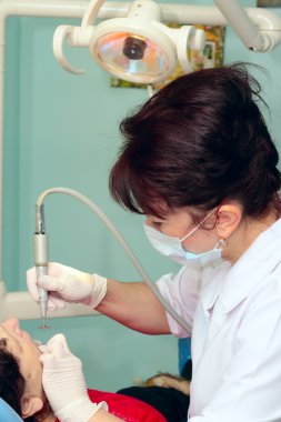 Dentist treating a patient clipart