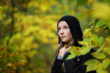 A girl is in an autumn park clipart