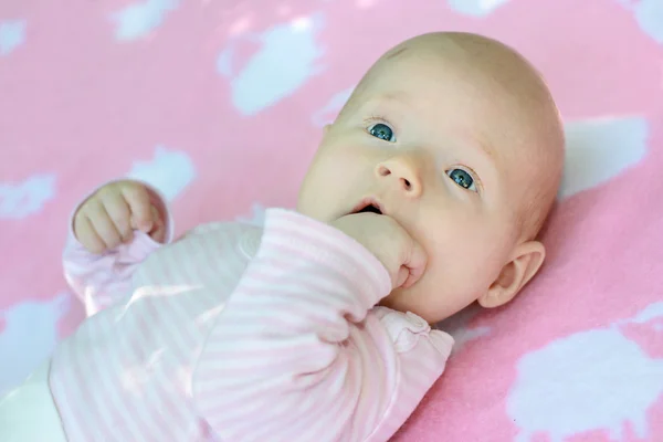 stock image A portrait of little child is in pink tones