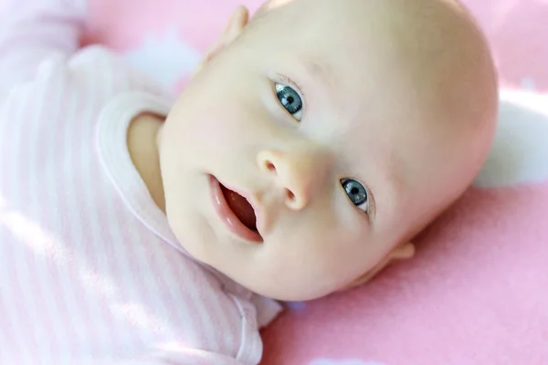 stock image A close up portrait of little child is in pink tones