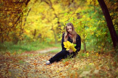 A girl is in an autumn park clipart