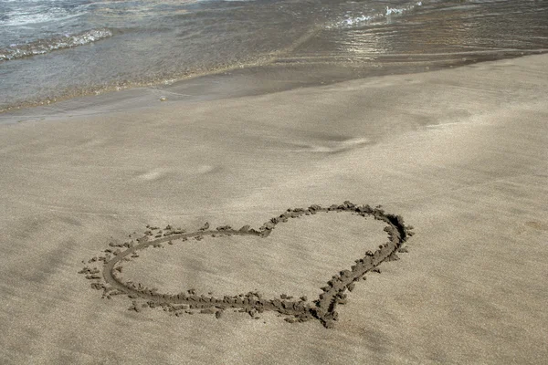 Stock image Heart on sand on ocean beach