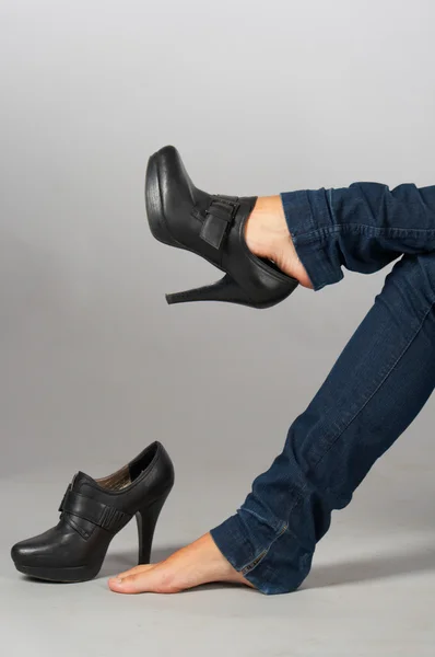 stock image Female legs and shoes. Taking on.