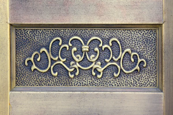 Enchased in metal decorative pattern on the wall — Stock Photo, Image