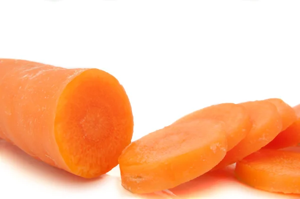 stock image Close and low level of a partially sliced carrot arranged over white.