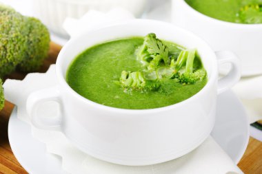 Broccoli fresh green soup in white bowl served for dinner clipart