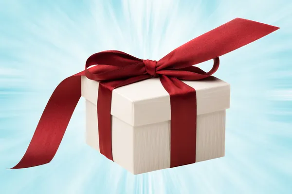Белый подарочный ящик с красным бантом — стоковое фото