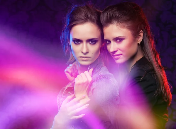 stock image Female twins in colored light stripes.