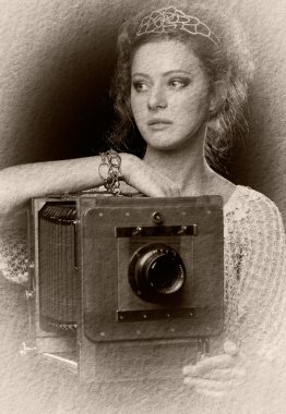 Young woman near the old camera clipart