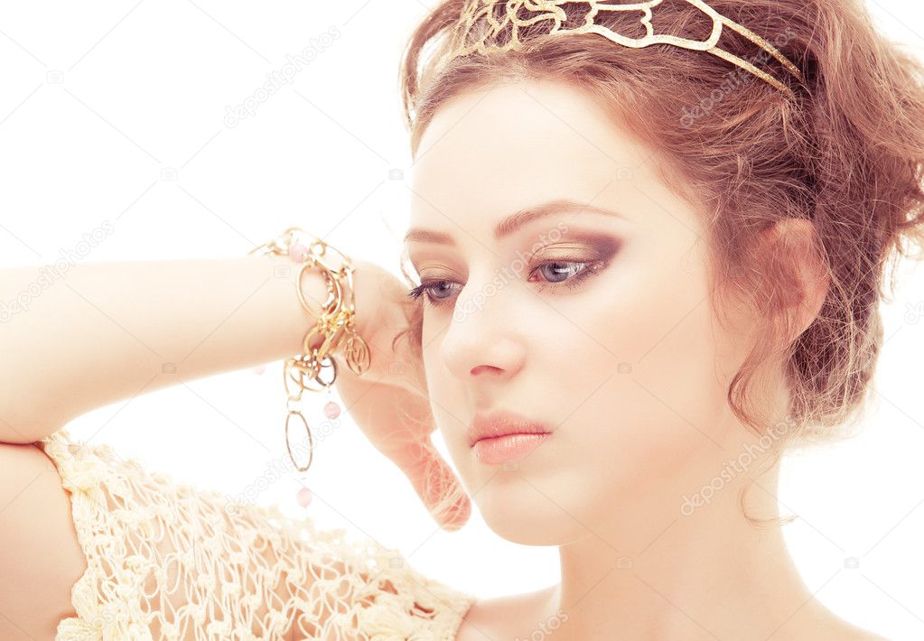 Goddess in a diadem and bracelets of gold, isolated on white background.