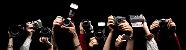 Raised hands holding photocameras clipart
