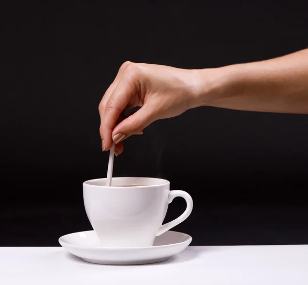Woman stir sugar in cup of coffee — Stock Photo, Image