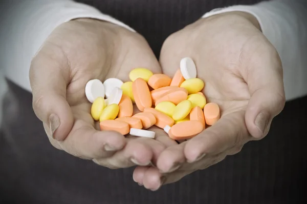 Woman hands holding pills — Stock Photo, Image