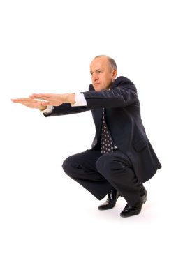 Businessman limbering up clipart