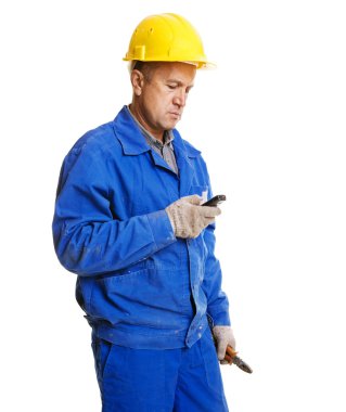 Worker reading message in his mobile phone clipart