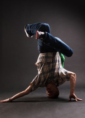 Breakdancer standing in complicated pose clipart