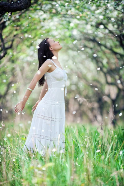 Carefree young woman in white dress — Stock Photo, Image