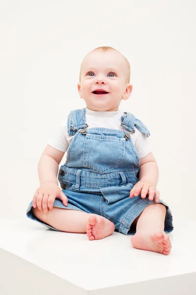 Happy baby in dungarees — Stock Photo, Image