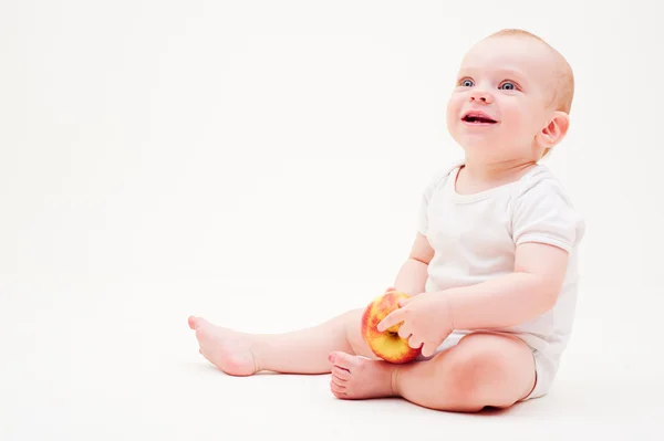 Laughing baby with apple — Stock Photo, Image