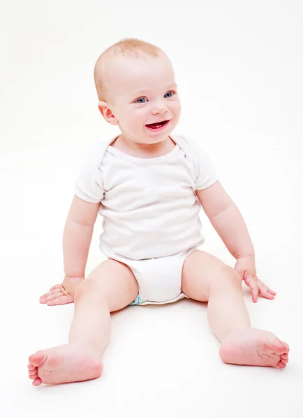 Smiley baby sitting on the floor — Stock Photo, Image
