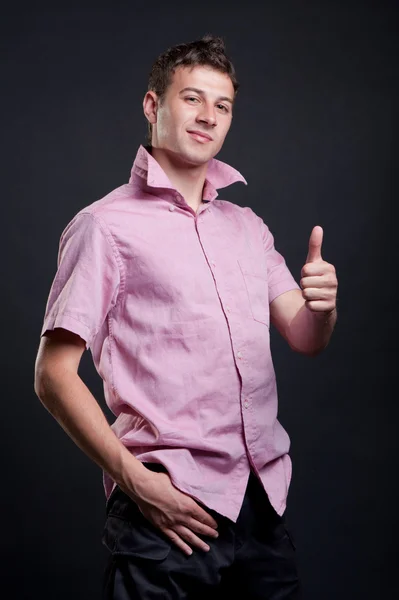 Pohledný chlap ukazuje palec — Stock fotografie