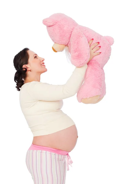 Mujer embarazada con osito de peluche rosa — Stok fotoğraf