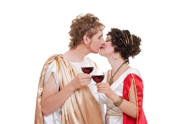 Kissing couple with glasses of wine — Stock Photo, Image